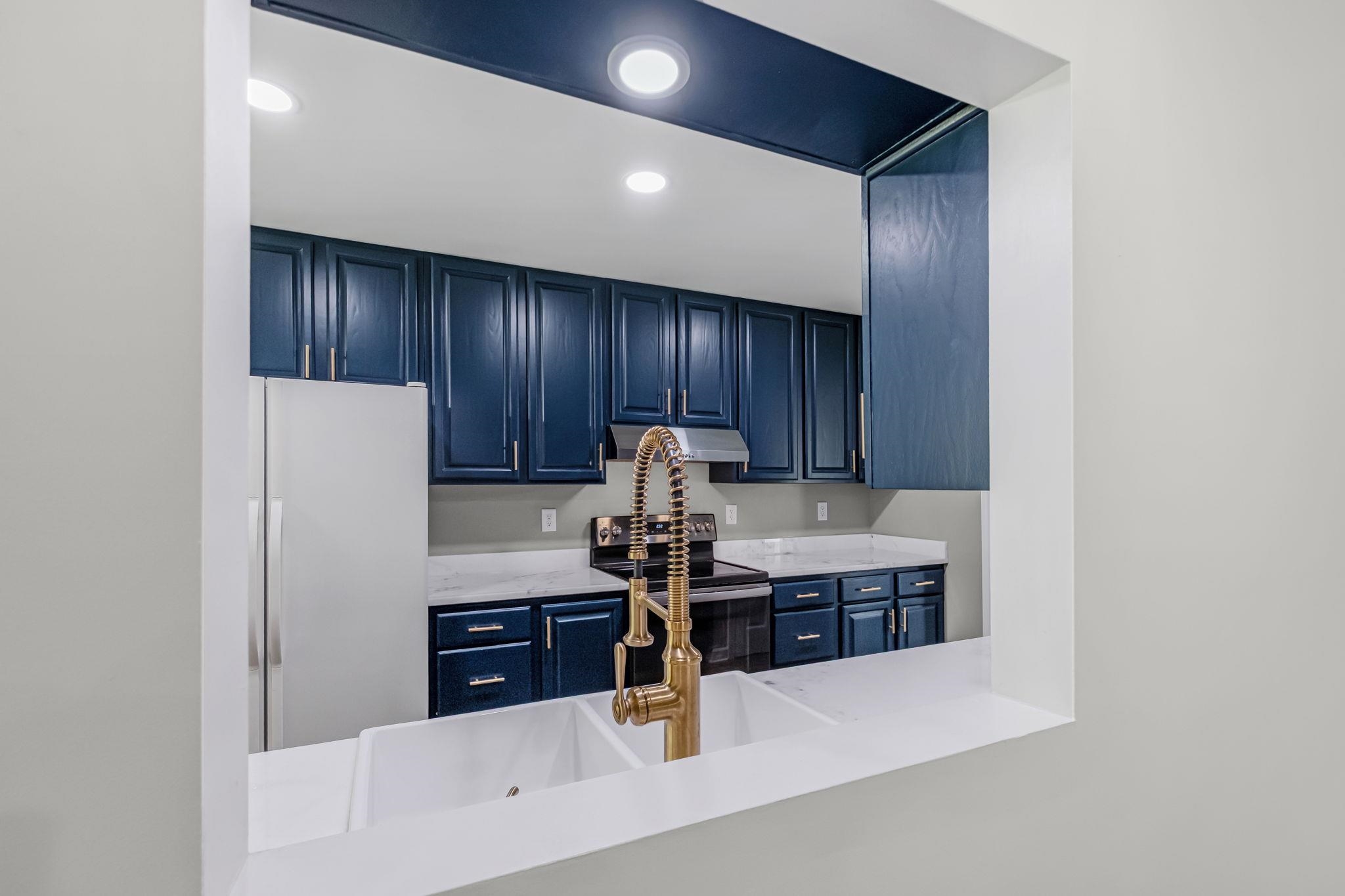 4729 Cedar Ridge Drive Millington, TN 38053 - Photo 8 of 40 Kitchen pass-through featuring dual white undermount sinks with a gold-tone gooseneck faucet