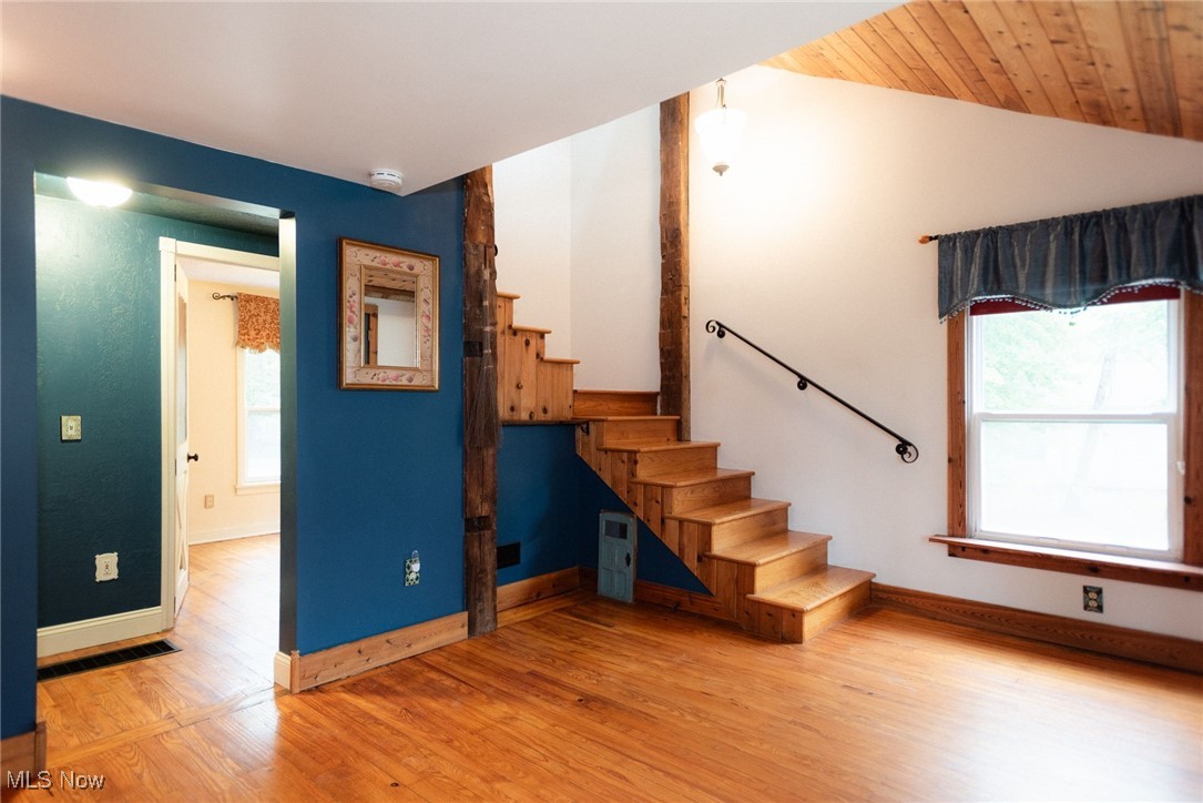 7342 Peck Road Ravenna, OH 44266 - Photo 3 of 20 Stairs featuring wood finished floors and lofted ceiling