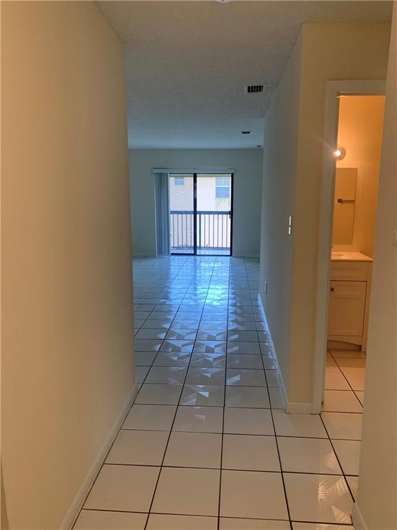 6001 Shaker Wood Circle, Unit 208 Tamarac, FL 33319 - Photo 1 of 13 a view of a hallway