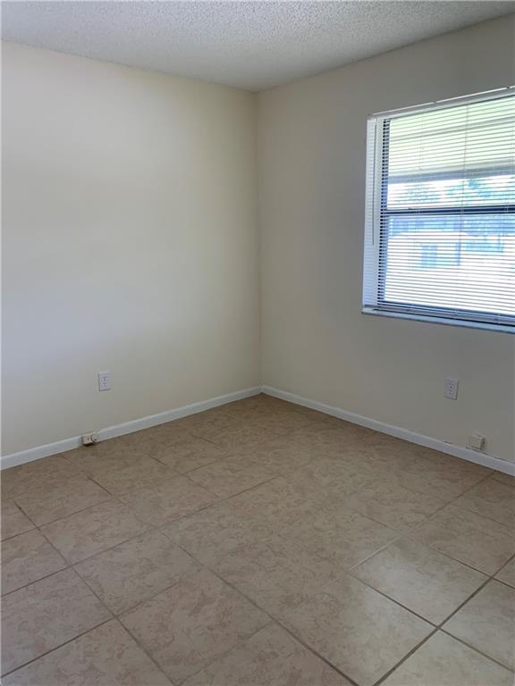 6001 Shaker Wood Circle, Unit 208 Tamarac, FL 33319 - Photo 12 of 13 a view of an empty room and window