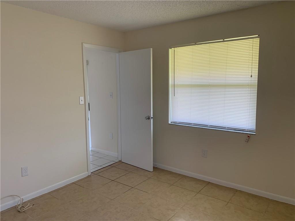6001 Shaker Wood Circle, Unit 208 Tamarac, FL 33319 - Photo 7 of 13 a view of an empty room with a window
