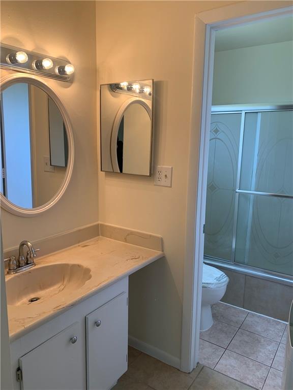 6001 Shaker Wood Circle, Unit 208 Tamarac, FL 33319 - Photo 10 of 13 a bathroom with a granite countertop sink toilet and shower