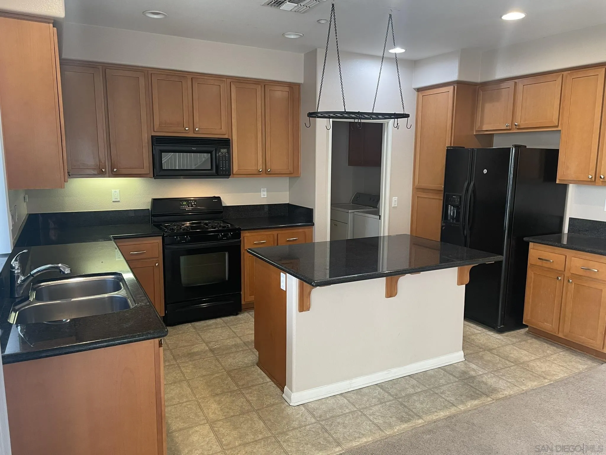 347 Borden Road San Marcos, CA 92069 - Photo 5 of 16 a kitchen with stainless steel appliances granite countertop a refrigerator a stove a sink and a microwave
