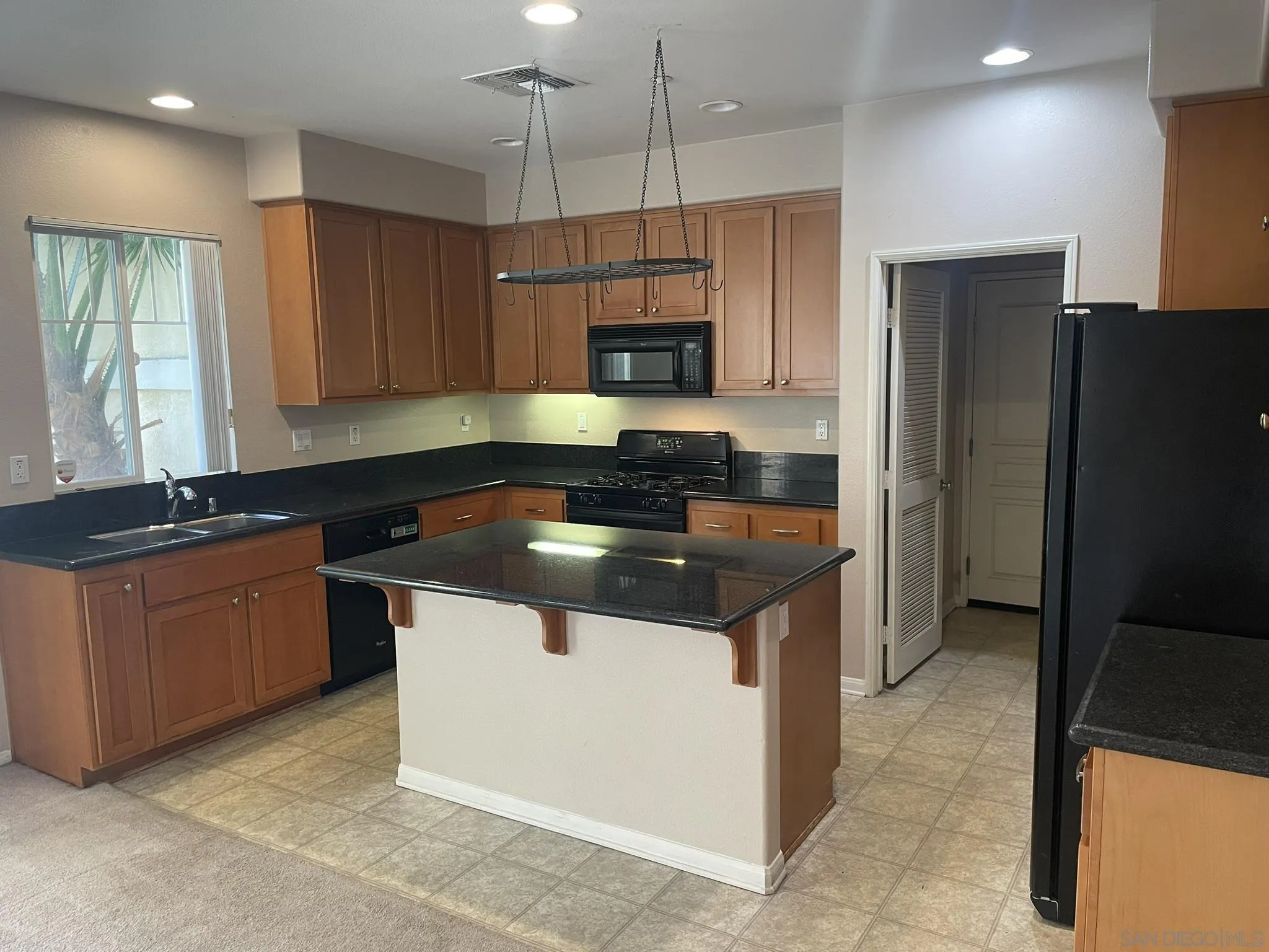 347 Borden Road San Marcos, CA 92069 - Photo 6 of 16 a kitchen with stainless steel appliances granite countertop a stove a refrigerator and a sink