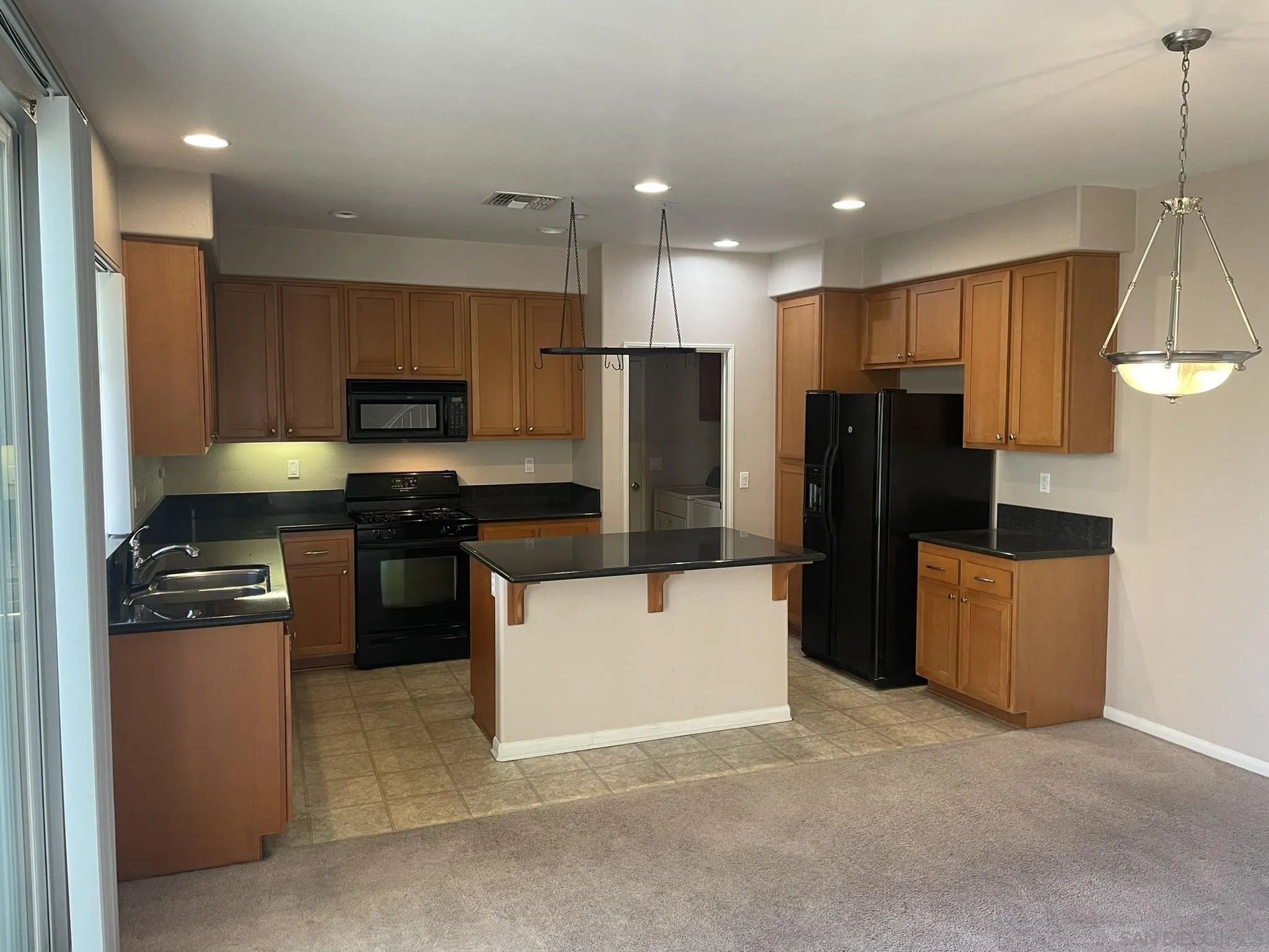 347 Borden Road San Marcos, CA 92069 - Photo 8 of 16 a kitchen with stainless steel appliances a refrigerator stove microwave and cabinets