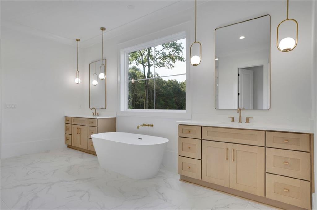 3903 Indian Shoals Road Southeast Bethlehem, GA 30620 - Photo 15 of 35 a bathroom with a double vanity sink mirror and bathtub