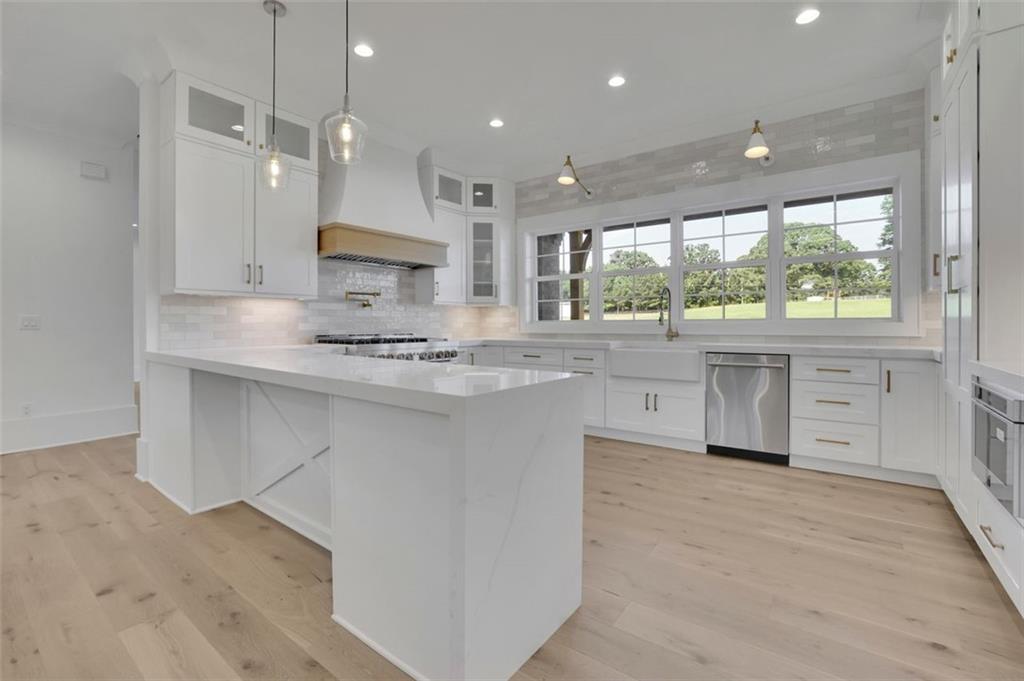 3903 Indian Shoals Road Southeast Bethlehem, GA 30620 - Photo 27 of 35 a kitchen with stainless steel appliances granite countertop a stove a sink and a microwave