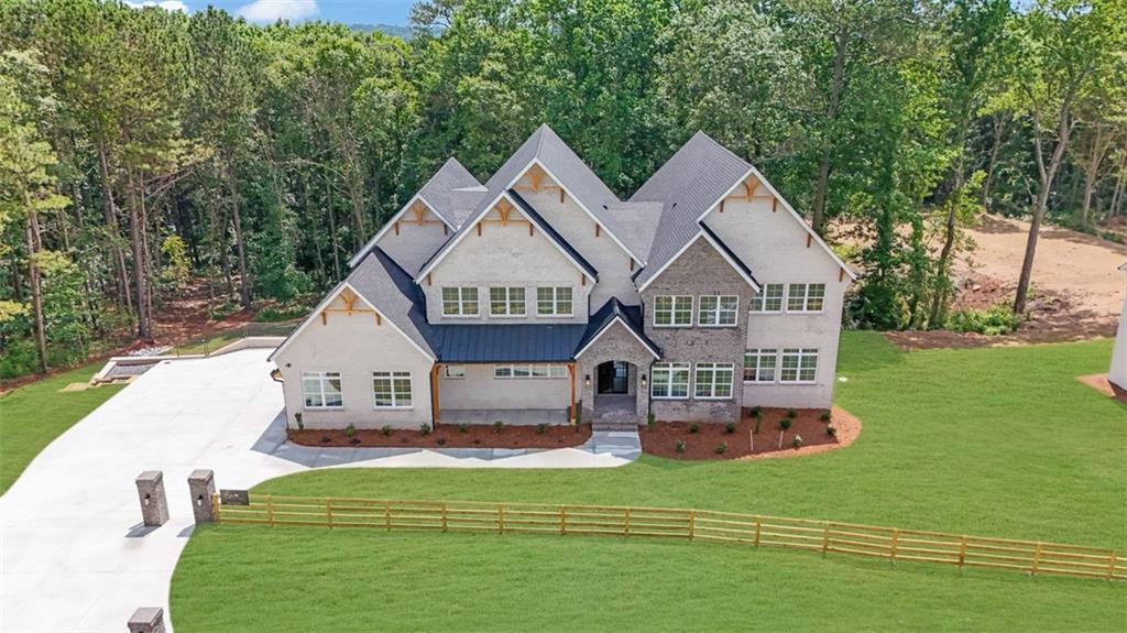 3903 Indian Shoals Road Southeast Bethlehem, GA 30620 - Photo 3 of 35 a front view of a house with a garden and trees