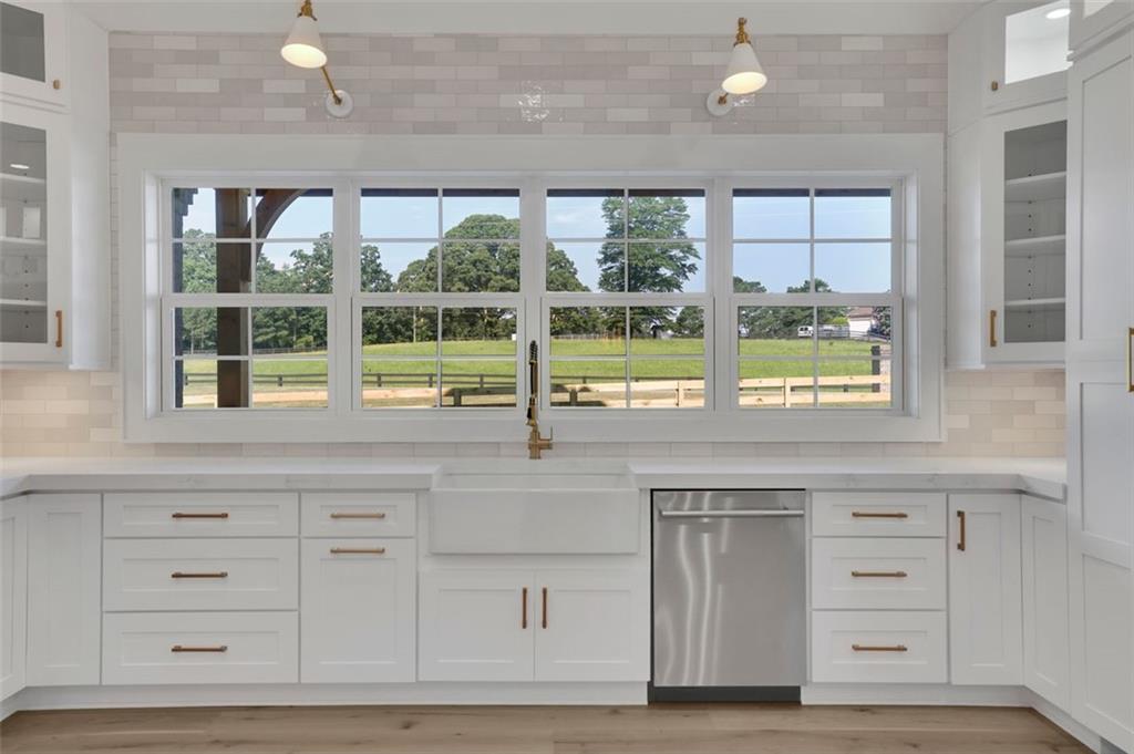 3903 Indian Shoals Road Southeast Bethlehem, GA 30620 - Photo 31 of 35 a kitchen with granite countertop a stove a sink and a large window