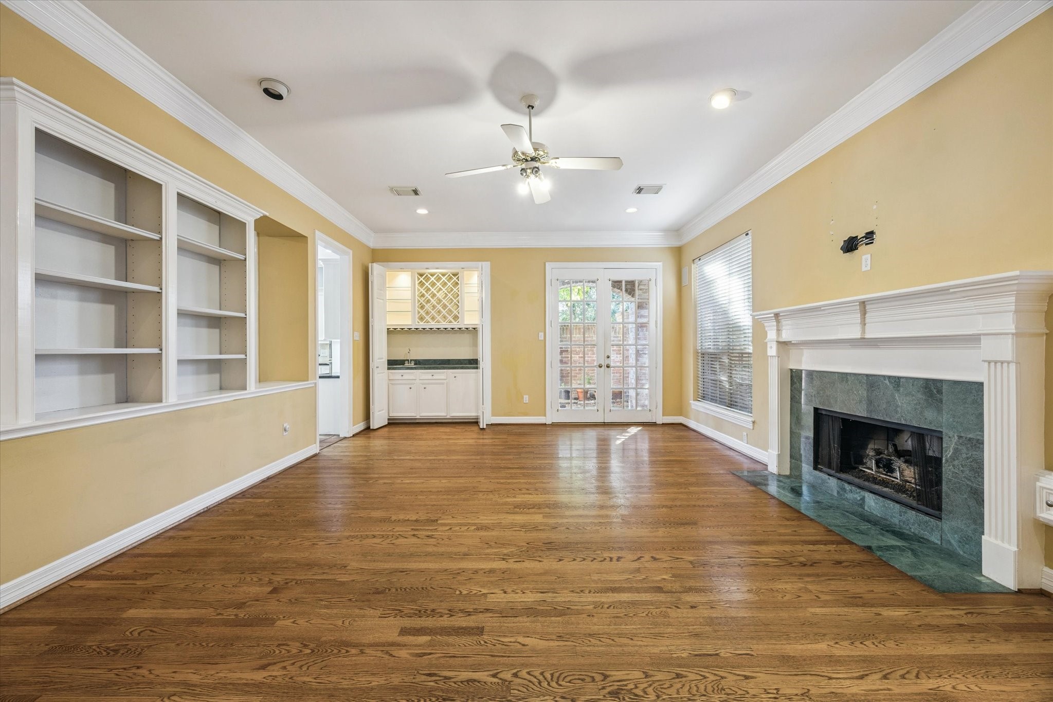 2410 Briar Ridge Drive Houston, TX 77057 - Photo 3 of 12 a view of an empty room with a fireplace and a window