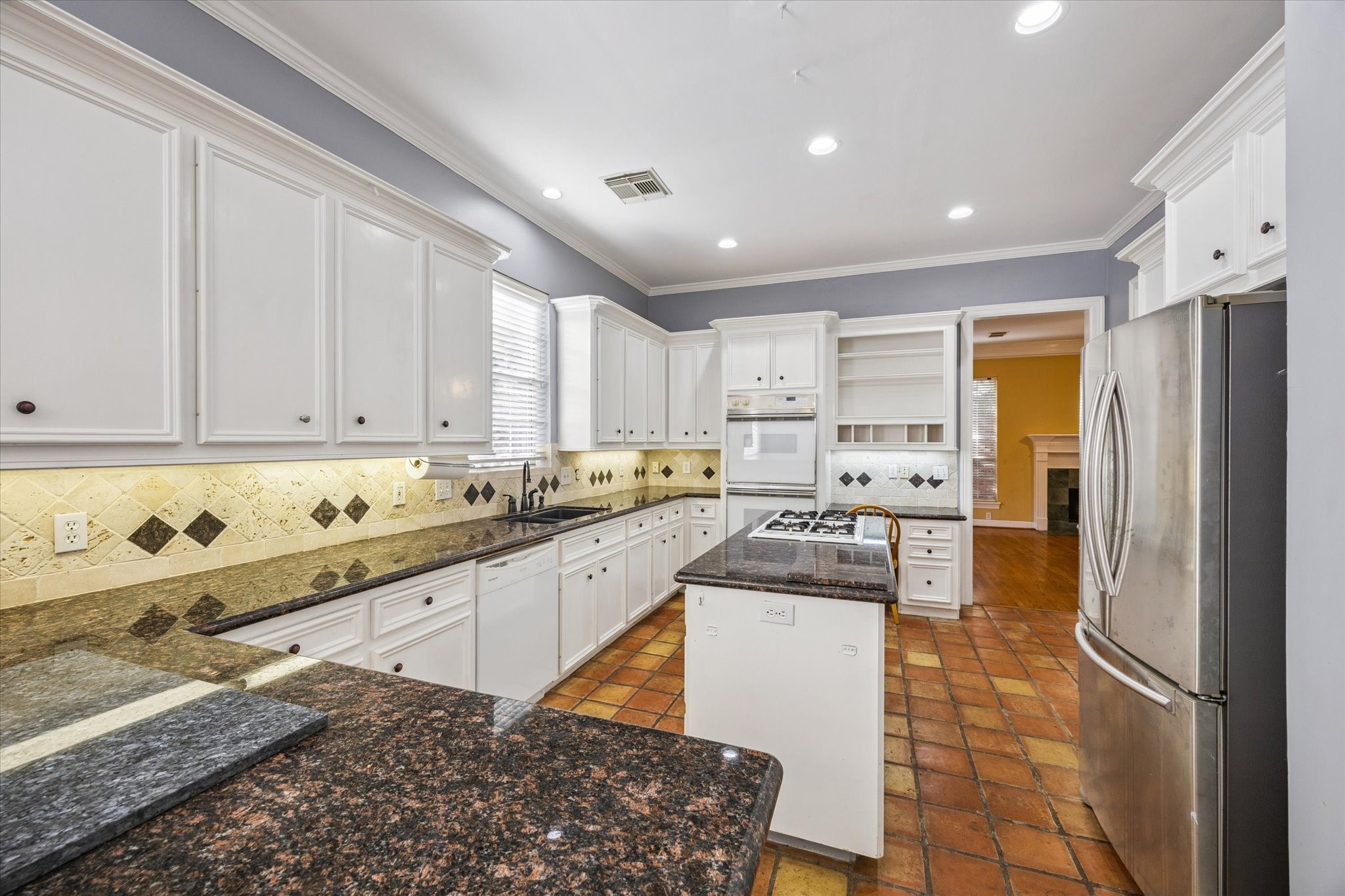 2410 Briar Ridge Drive Houston, TX 77057 - Photo 4 of 12 a kitchen with stainless steel appliances granite countertop a refrigerator and a stove top oven