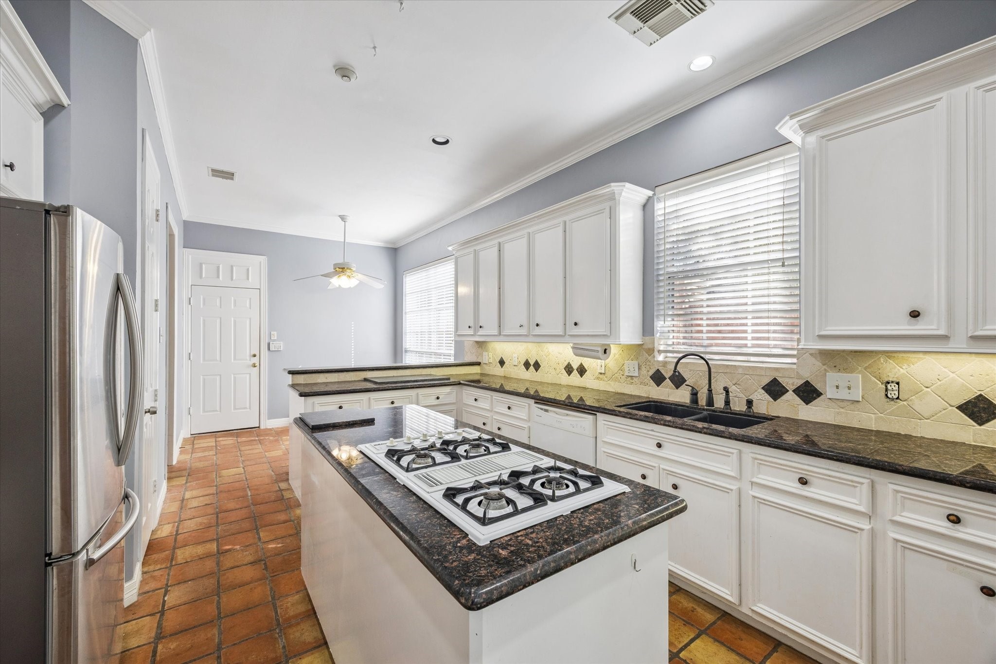 2410 Briar Ridge Drive Houston, TX 77057 - Photo 5 of 12 a kitchen with stainless steel appliances granite countertop a stove a sink and a refrigerator