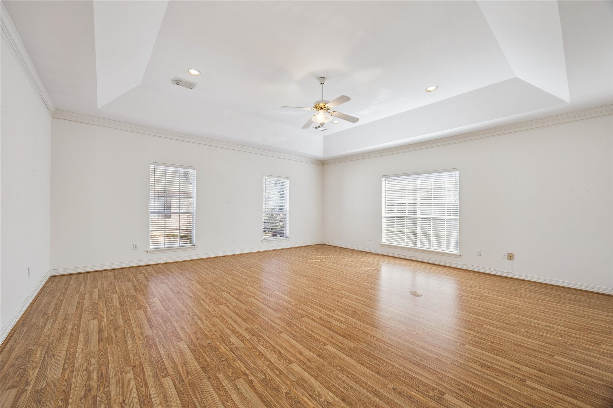 2410 Briar Ridge Drive Houston, TX 77057 - Photo 6 of 12 an empty room with wooden floor and windows