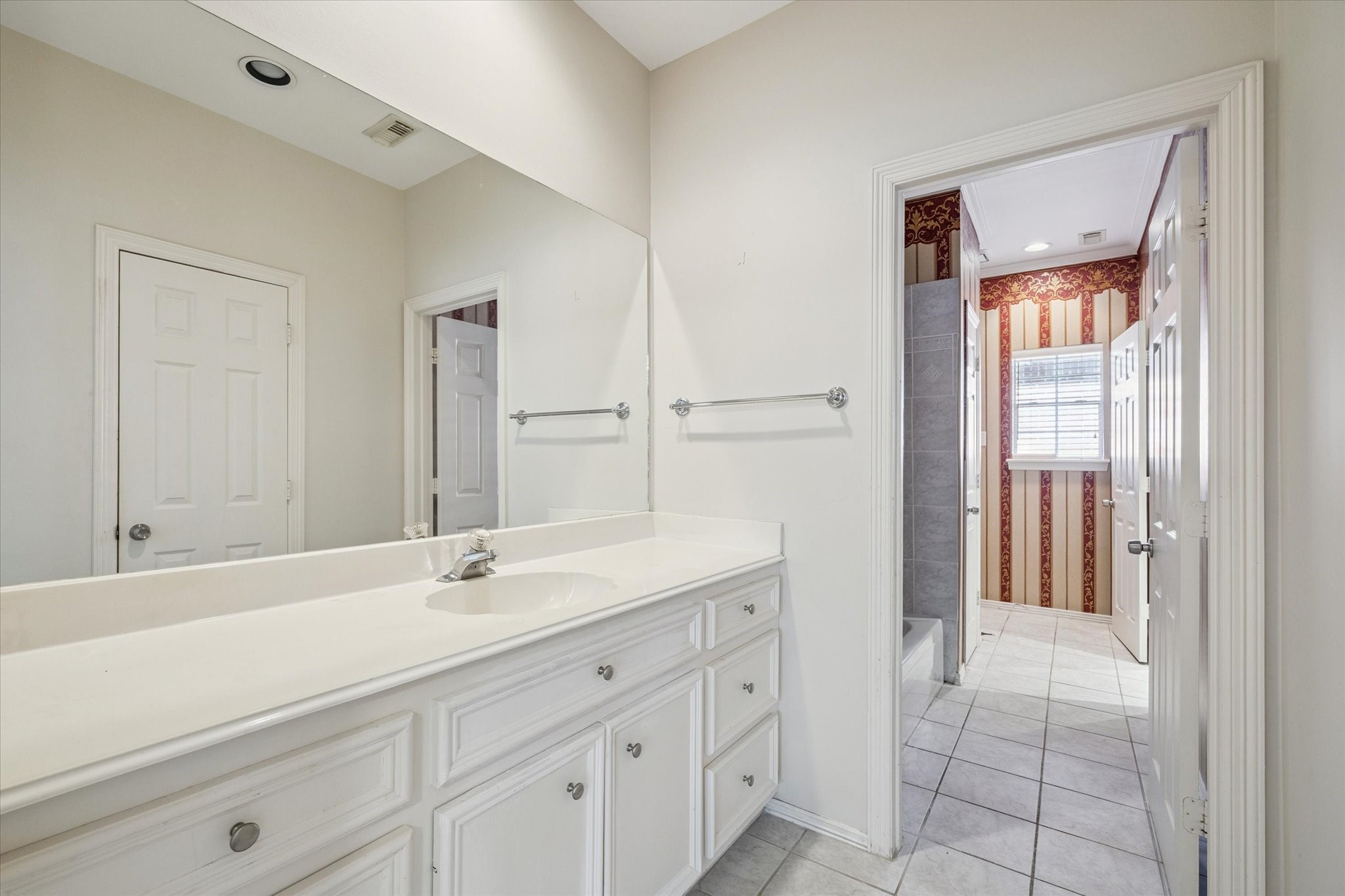 2410 Briar Ridge Drive Houston, TX 77057 - Photo 9 of 12 a bathroom with a sink and a mirror