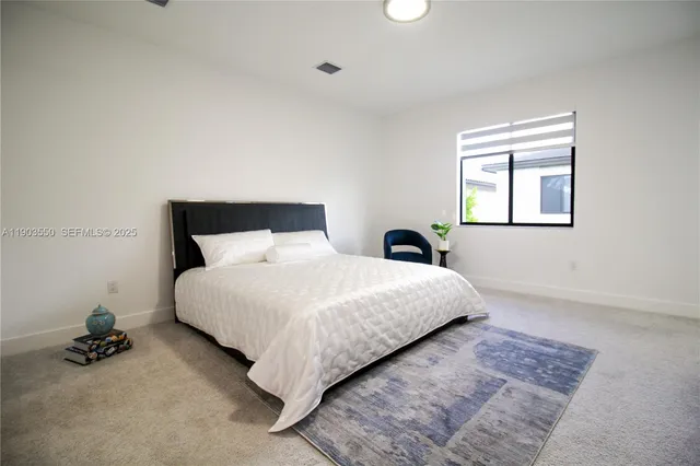 a bedroom with a bed and window