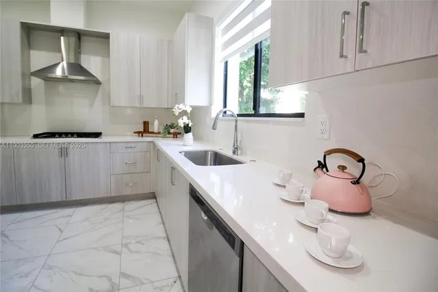 a kitchen with kitchen island a sink appliances and cabinets