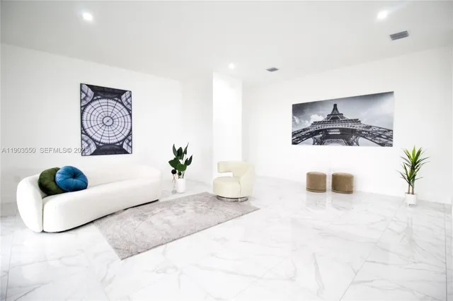 a living room with furniture and a potted plant