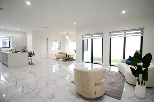 a living room with furniture and a large window with outer view