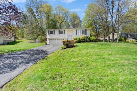 a view of a house with yard and tree s