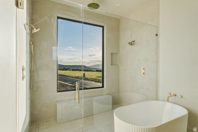 923 North Emery Lane Elk Ridge, UT 84651 - Photo 32 of 101 Contemporary bathroom featuring a spacious glass-enclosed shower with gold-tone fixtures, a freestanding soaking tub, a built-in shower bench, and a large picture window
