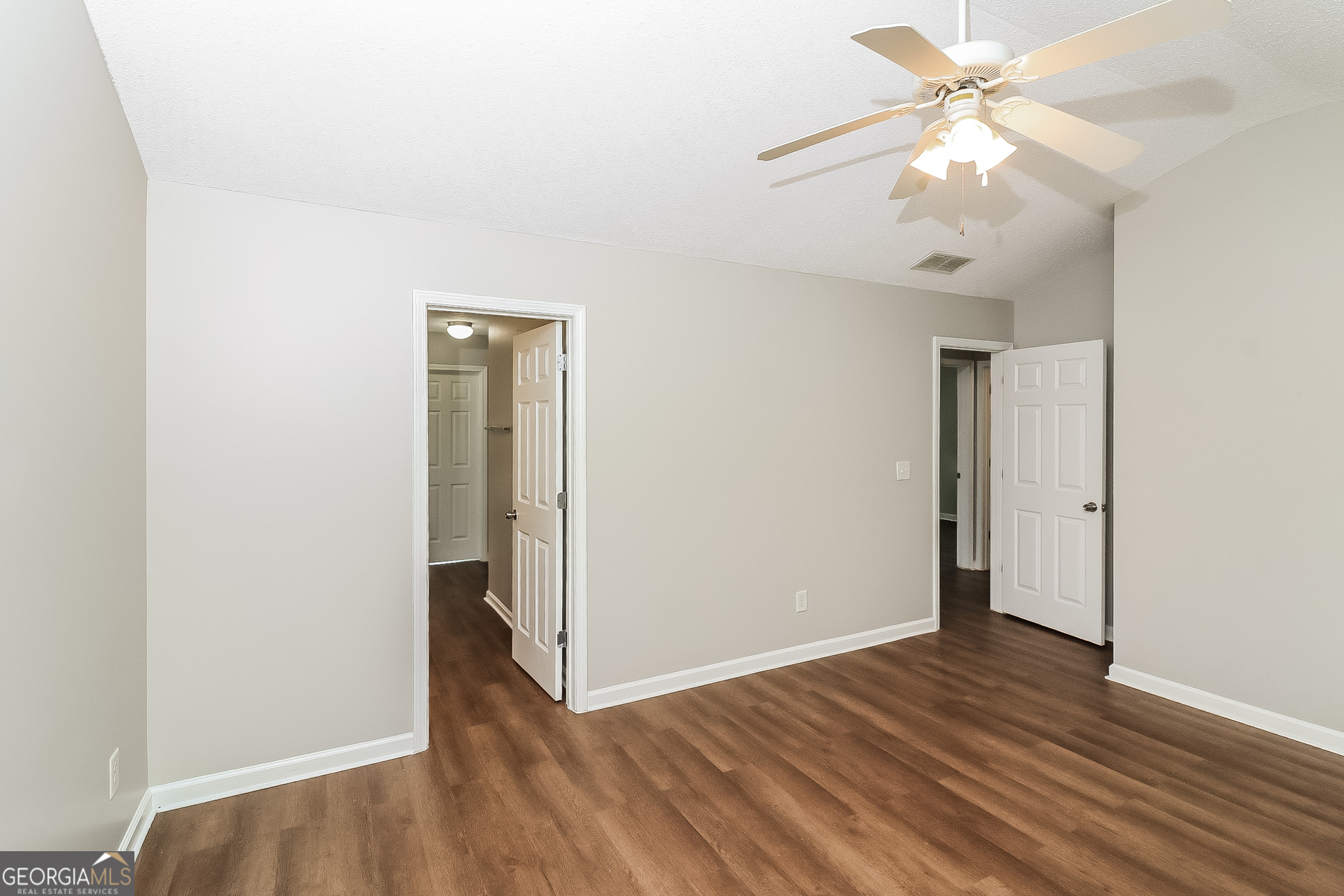 59 Greystone Ridge Hiram, GA 30141 - Photo 13 of 15 an empty room with wooden floor and fan