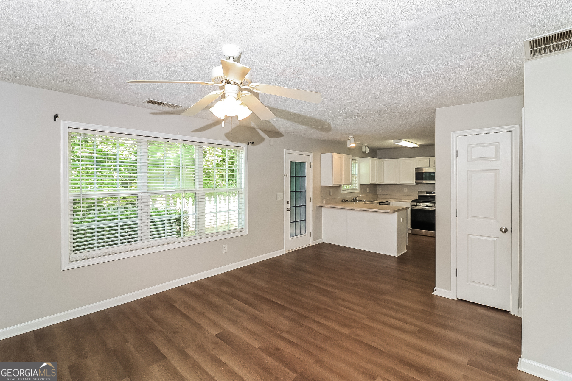 59 Greystone Ridge Hiram, GA 30141 - Photo 4 of 15 a view of an empty room with window and wooden floor