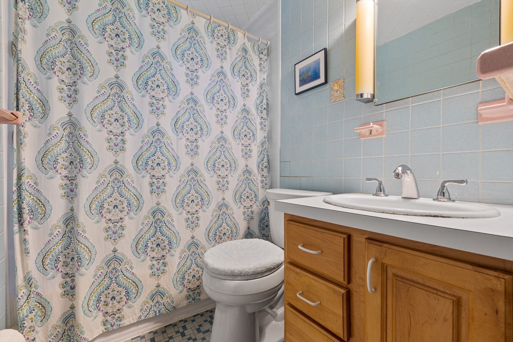 38 Cutter Hill Road Arlington, MA 02474 - Photo 12 of 23 a bathroom with a granite countertop toilet sink and mirror