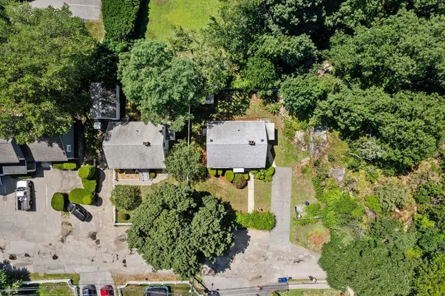 an aerial view of a house with swimming pool garden and patio