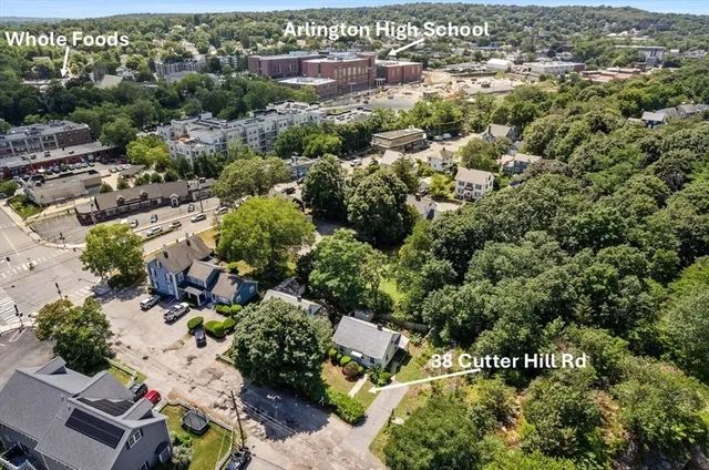 an aerial view of a houses with a yard