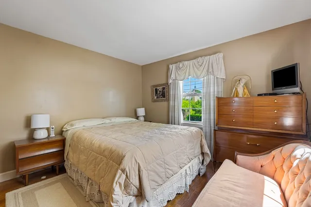 a bedroom with a bed and a flat tv screen