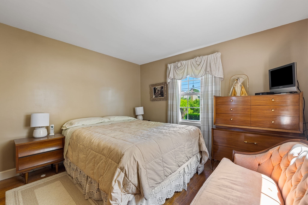 38 Cutter Hill Road Arlington, MA 02474 - Photo 9 of 23 a bedroom with a bed and a flat tv screen