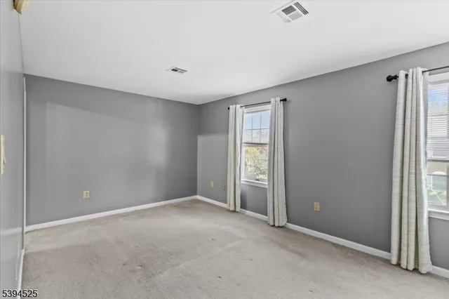 a view of an empty room and a window