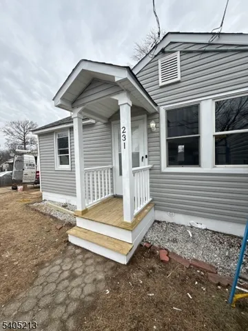 a view of a house with a yard and wooden floor