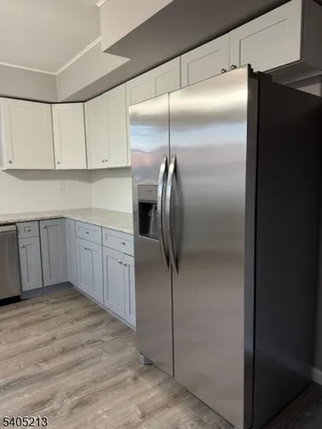 a kitchen with cabinets and stainless steel appliances