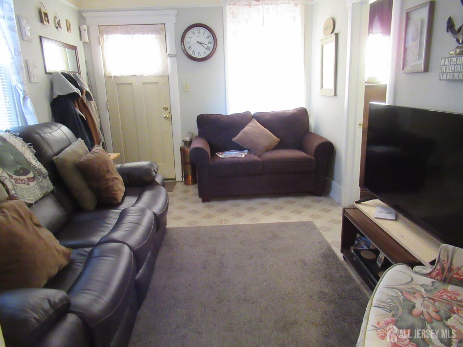 82 Pulaski Avenue Carteret, NJ 07008 - Photo 12 of 47 a living room with furniture and a flat screen tv