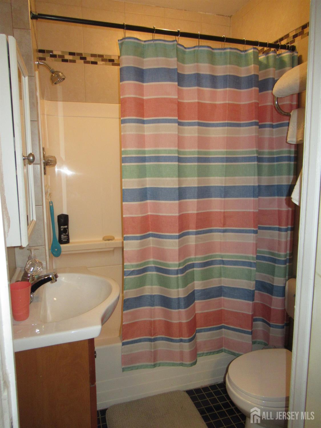 82 Pulaski Avenue Carteret, NJ 07008 - Photo 17 of 47 a bathroom with a sink and a mirror