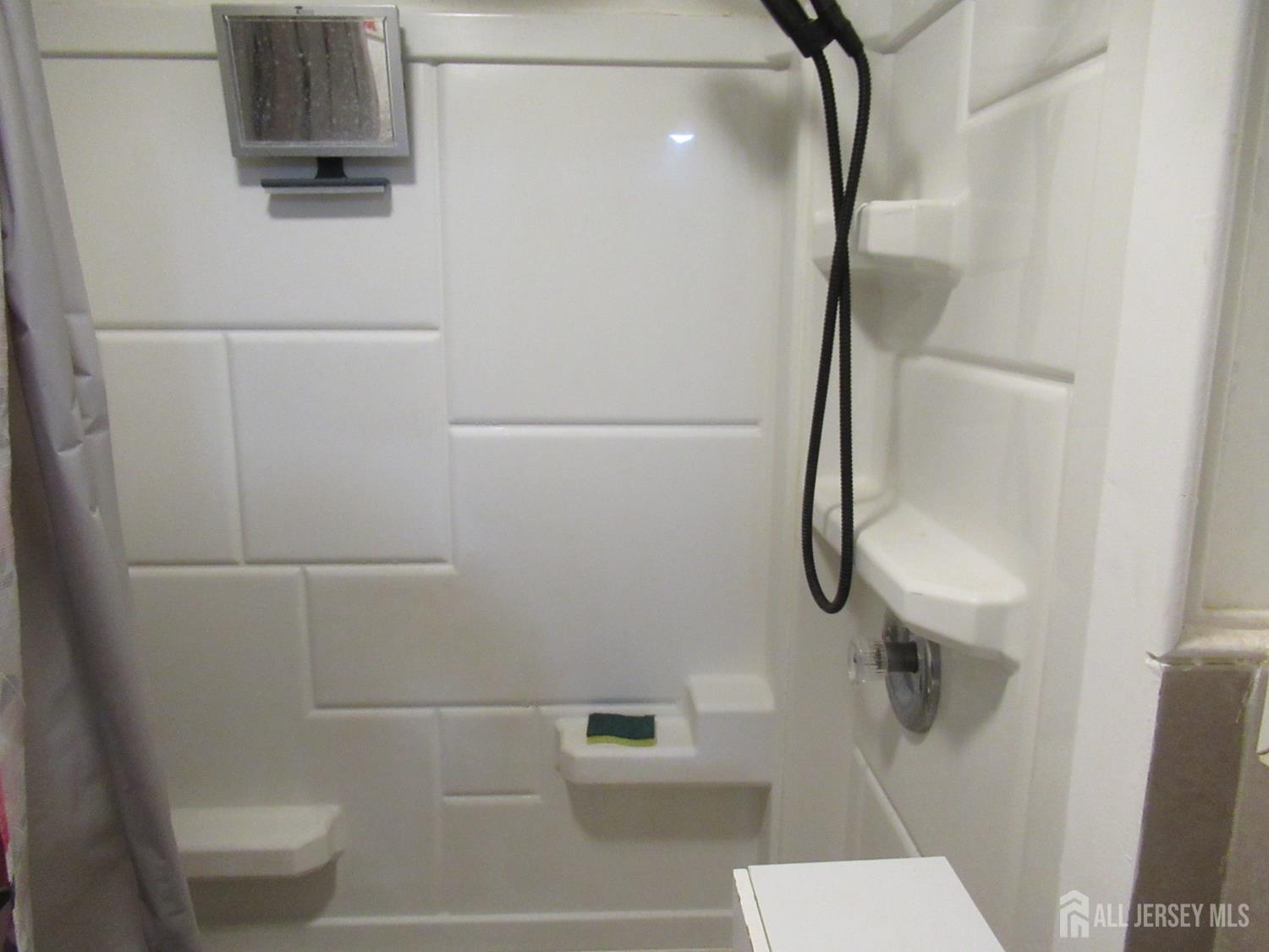 82 Pulaski Avenue Carteret, NJ 07008 - Photo 21 of 47 a bathroom with a shower and toilet
