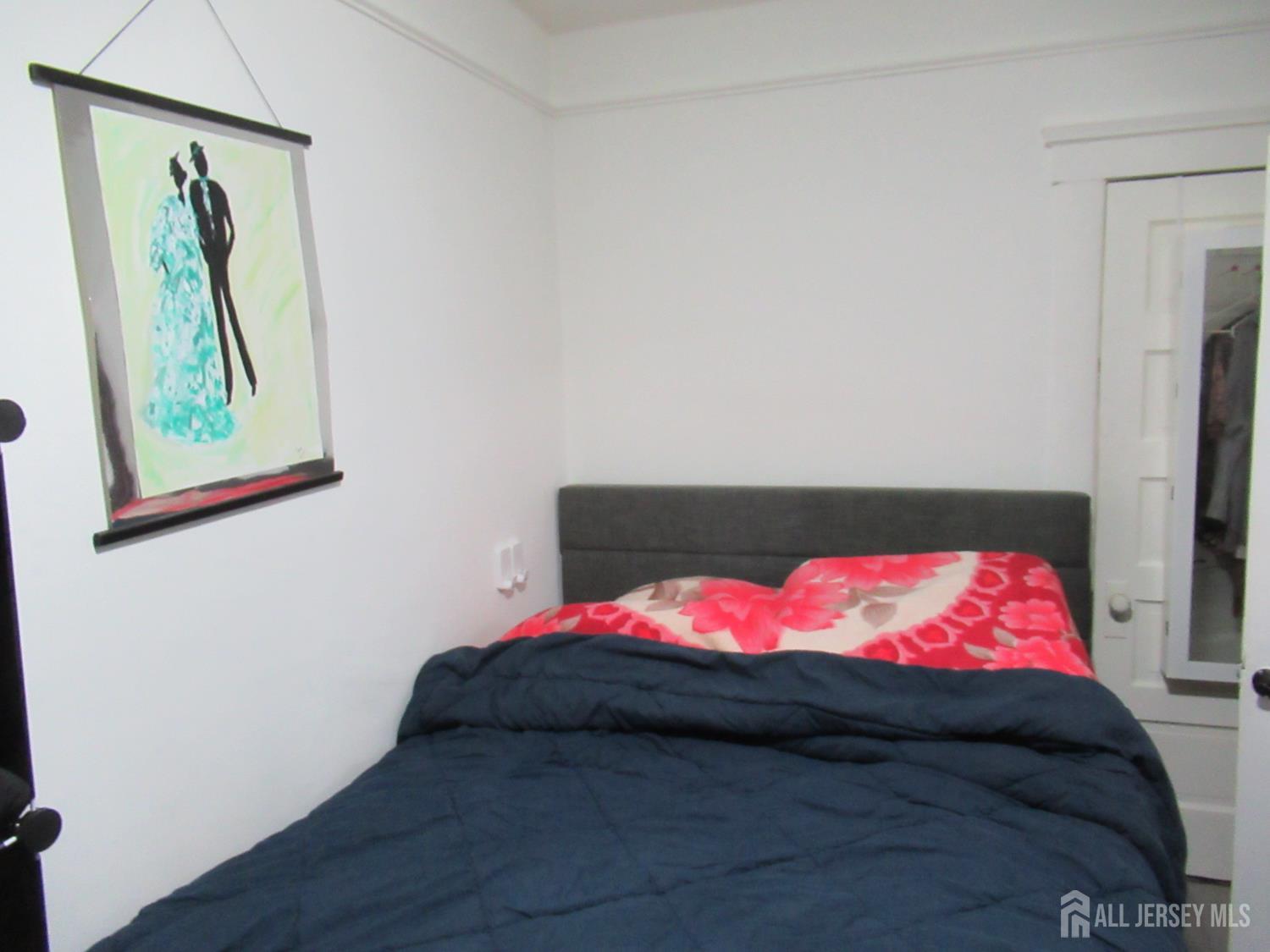 82 Pulaski Avenue Carteret, NJ 07008 - Photo 22 of 47 a bedroom with a bed and a painting on the wall