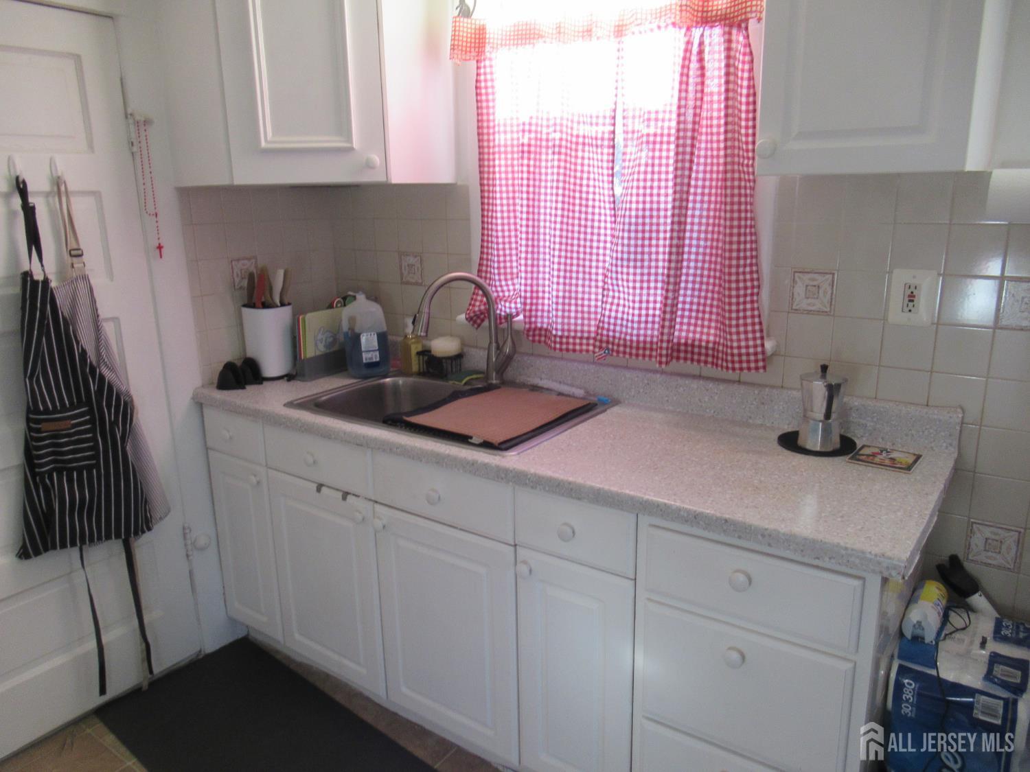 82 Pulaski Avenue Carteret, NJ 07008 - Photo 28 of 47 a kitchen with sink and cabinets