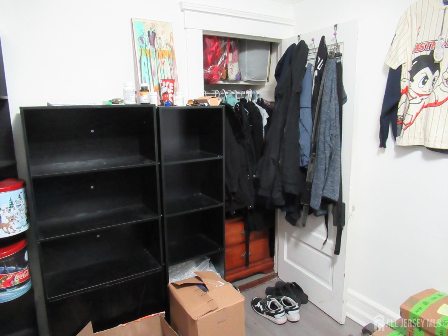 82 Pulaski Avenue Carteret, NJ 07008 - Photo 31 of 47 a view of walk in closet with clothes and shoes