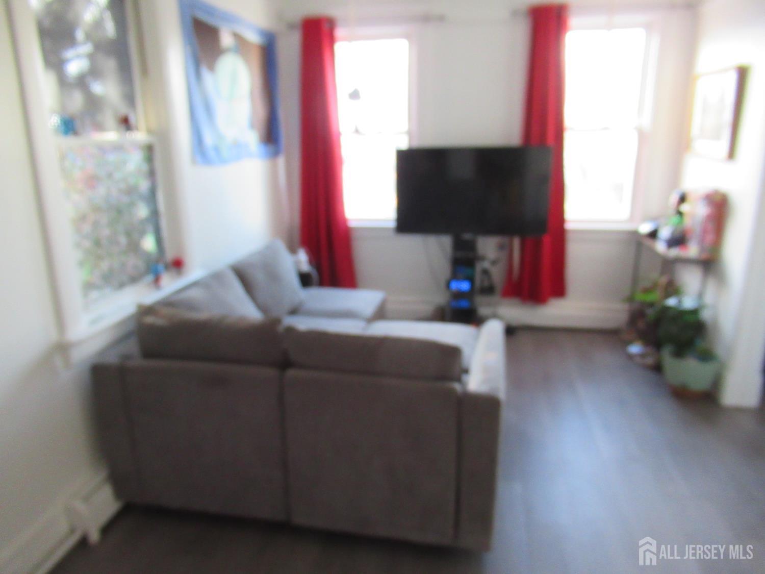 82 Pulaski Avenue Carteret, NJ 07008 - Photo 34 of 47 a living room with furniture and a flat screen tv