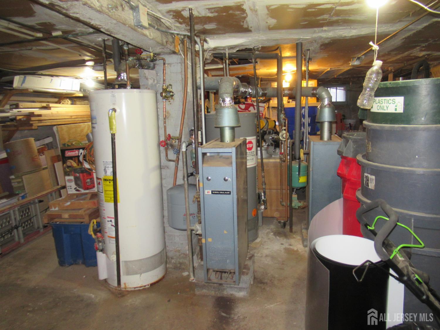 82 Pulaski Avenue Carteret, NJ 07008 - Photo 45 of 47 a view of a storage room with water heater and racks
