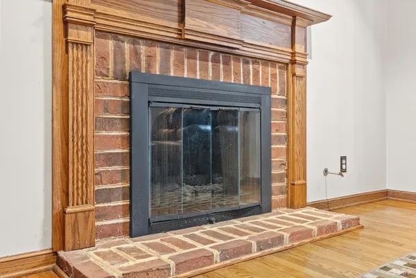 a view of a livingroom with a fireplace and wooden floor