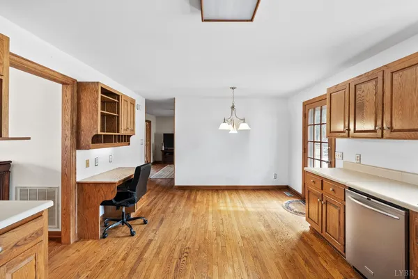 a view of a kitchen with wooden floor and electronic appliances