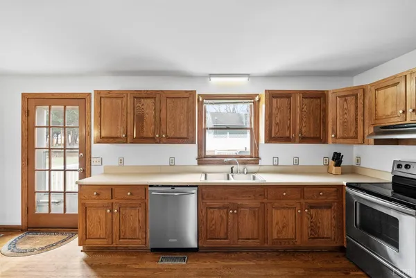 a kitchen with a sink stove and cabinets