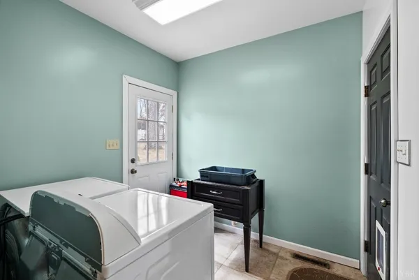 a view of a hallway with a bedroom and wooden floor