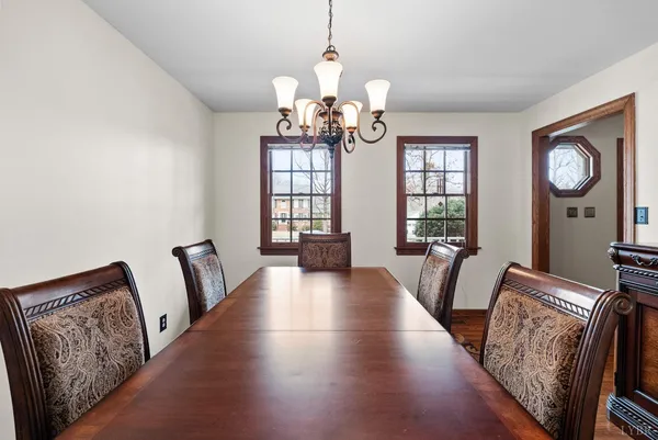 a view of a livingroom with furniture wooden floor and windows