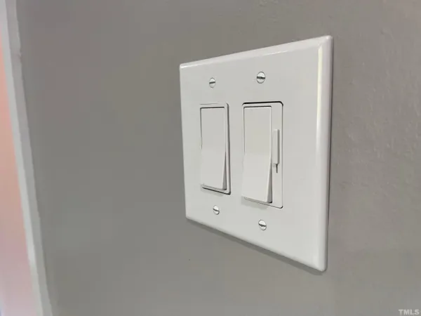 a view of a house with a wooden fence