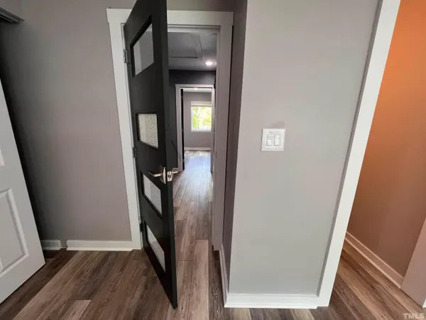 a view of staircase with railing and a window