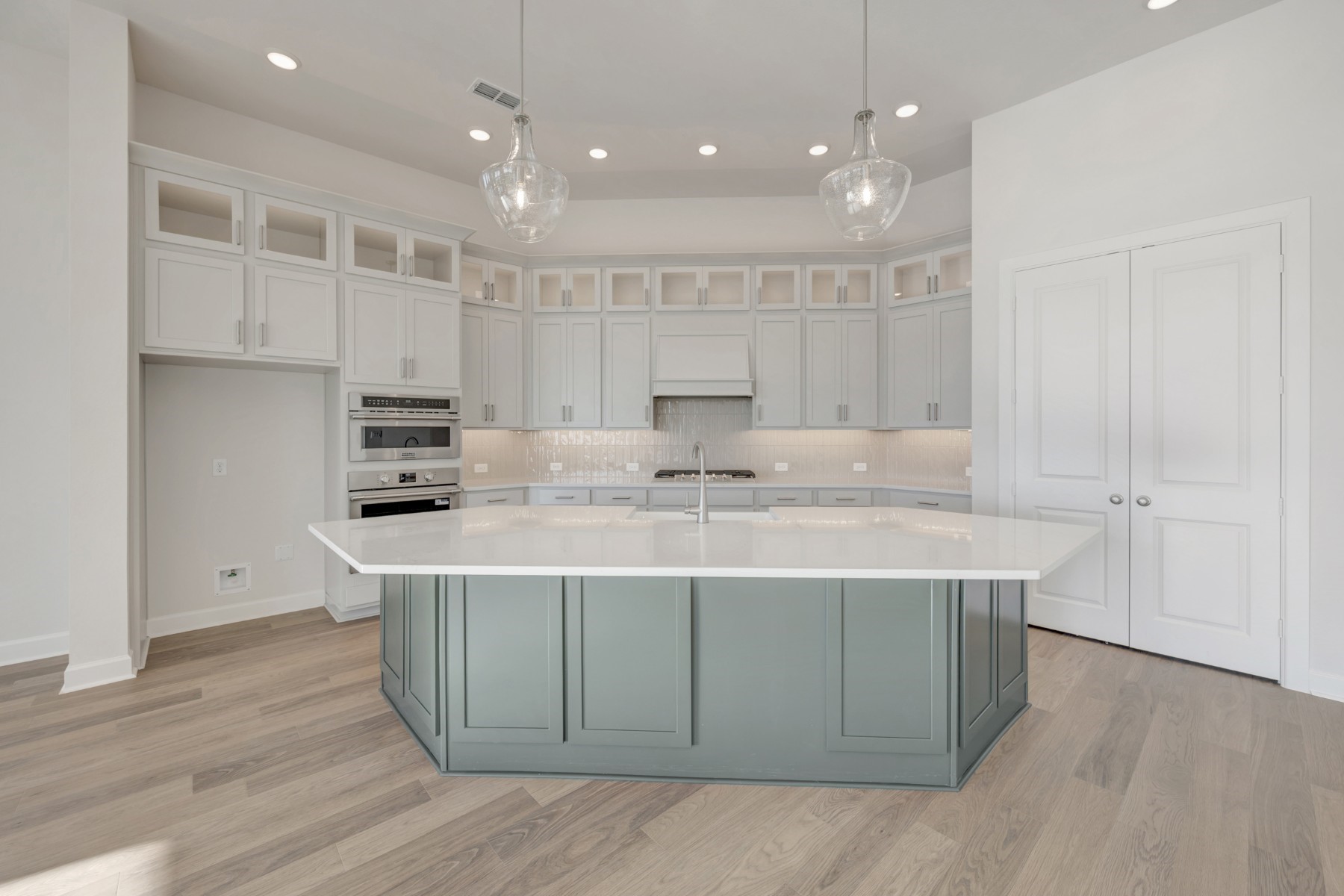646 Walnut Br Drive Rosenberg, TX 77471 - Photo 27 of 46 a kitchen with kitchen island stainless steel appliances a sink a stove a refrigerator and white cabinets
